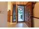Welcoming entryway featuring an open door, wood floors, and an adjacent decorative wall with a lovely wreath at 929 Torchwood Dr, Deland, FL 32724