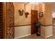 Elegant foyer with wood-look flooring, beautiful wallpaper, and warm lighting to welcome guests at 929 Torchwood Dr, Deland, FL 32724