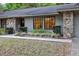 Inviting front entrance with stone facade and well-maintained landscaping that provides curb appeal at 929 Torchwood Dr, Deland, FL 32724