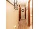 Hallway with wood-look flooring and doors, complemented by light walls and tasteful decor at 929 Torchwood Dr, Deland, FL 32724