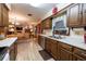Bright kitchen with wooden cabinets, countertops and flooring opening up to the living room at 929 Torchwood Dr, Deland, FL 32724