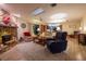 Cozy living room with a stone fireplace, skylight, and comfortable seating for relaxation and entertainment at 929 Torchwood Dr, Deland, FL 32724