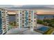 Striking exterior of condo with balconies, pool, and tennis court offering stunning sunset views at 935 N Halifax Ave # 309, Daytona Beach, FL 32118