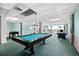 The game room features a pool table and foosball table, providing entertainment for residents and guests at 935 N Halifax Ave # 309, Daytona Beach, FL 32118