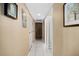Hallway featuring white tile flooring, neutral walls and access to storage and additional rooms at 935 N Halifax Ave # 309, Daytona Beach, FL 32118