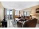 Comfortable living room featuring a balcony with scenic water views and neutral decor at 935 N Halifax Ave # 309, Daytona Beach, FL 32118