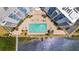 Aerial shot of a large swimming pool situated between two buildings and near the water at 935 N Halifax Ave # 309, Daytona Beach, FL 32118