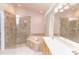 Luxurious bathroom boasts a glass-enclosed shower, a large soaking tub, and a spacious vanity at 1222 Brandy Lake View Cir, Winter Garden, FL 34787