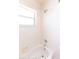 Clean bathroom features a shower/tub combo with white tile surround and a small window at 1222 Brandy Lake View Cir, Winter Garden, FL 34787