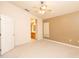 Comfortable bedroom features a ceiling fan, an en-suite bathroom, and plush carpeting at 1222 Brandy Lake View Cir, Winter Garden, FL 34787