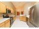Bright kitchen featuring wooden cabinets, stainless steel appliances, and tiled flooring at 1222 Brandy Lake View Cir, Winter Garden, FL 34787