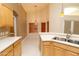 Kitchen features wooden cabinets, white countertops, stainless steel sink, and tiled flooring at 1222 Brandy Lake View Cir, Winter Garden, FL 34787
