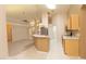 Open-concept kitchen features light-colored cabinetry and appliances, and tiled floors at 1222 Brandy Lake View Cir, Winter Garden, FL 34787