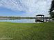 Scenic lake view featuring a wooden dock and gazebo, perfect for relaxation and enjoying nature at 1222 Brandy Lake View Cir, Winter Garden, FL 34787