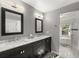 Modern bathroom featuring double vanity, dark cabinets, marble countertops, and a view of the lake at 1227 Baypoint Ct, Longwood, FL 32750