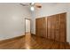 Bedroom with hardwood floors, a ceiling fan, and a closet with wood doors at 1227 Baypoint Ct, Longwood, FL 32750