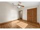 Sunny bedroom features a ceiling fan, hardwood floors, and lots of natural light at 1227 Baypoint Ct, Longwood, FL 32750