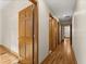 Hallway with hardwood floors, trim, and wood doors leading to various rooms at 1227 Baypoint Ct, Longwood, FL 32750