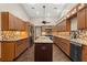 Spacious kitchen featuring a center island with granite countertops, custom cabinets, and stainless steel appliances at 1227 Baypoint Ct, Longwood, FL 32750