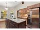 Open kitchen featuring an island, stainless steel refrigerator, custom cabinetry and sleek countertops at 1227 Baypoint Ct, Longwood, FL 32750
