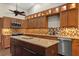 Well-lit kitchen with custom cabinetry, mosaic backsplash, granite countertops, and stainless steel appliances at 1227 Baypoint Ct, Longwood, FL 32750