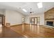 Spacious living room with hardwood floors, a stone fireplace, and bright natural light at 1227 Baypoint Ct, Longwood, FL 32750
