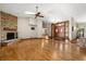 Bright living room with hardwood floors, a stone fireplace, skylights and a front door with sidelights at 1227 Baypoint Ct, Longwood, FL 32750