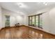 Bright living room featuring gleaming hardwood floors, natural lighting, and a beautiful bay window at 1227 Baypoint Ct, Longwood, FL 32750