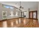 Spacious main bedroom with light hardwood floors, a ceiling fan, and wide windows to let the sunshine in at 1227 Baypoint Ct, Longwood, FL 32750
