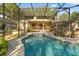 Relax and unwind in this sparkling swimming pool and attached spa with screened enclosure at 1227 Baypoint Ct, Longwood, FL 32750