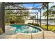 A sparkling screened-in pool with a view of the lake, providing a tranquil backyard retreat at 1227 Baypoint Ct, Longwood, FL 32750