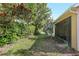 Well-maintained backyard featuring lush greenery, a manicured lawn, and a view of screened-in patio at 1386 Hazeldene Mnr, Deland, FL 32724