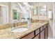 A well-lit bathroom with double sinks and granite countertops at 1386 Hazeldene Mnr, Deland, FL 32724