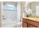 Well-lit bathroom with granite countertops, white shower and tub combination, and decorative accents at 1386 Hazeldene Mnr, Deland, FL 32724