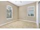 Bright, carpeted bedroom with two windows and ample natural light at 1386 Hazeldene Mnr, Deland, FL 32724