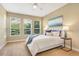 Bright bedroom with plush carpeting, a ceiling fan, and large windows at 1386 Hazeldene Mnr, Deland, FL 32724