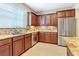 Kitchen featuring wooden cabinets, stainless steel appliances, and granite countertops at 1386 Hazeldene Mnr, Deland, FL 32724