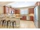 A well-lit kitchen with stainless steel appliances, granite countertops, and tile flooring at 1386 Hazeldene Mnr, Deland, FL 32724