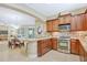 An open kitchen features stainless steel appliances, granite countertops, and dark wood cabinets at 1386 Hazeldene Mnr, Deland, FL 32724