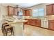 An inviting kitchen featuring wooden cabinets, granite countertops, and a stylish backsplash at 1386 Hazeldene Mnr, Deland, FL 32724