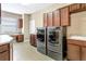 Well-appointed laundry room with built-in cabinets, sink, and modern washer and dryer at 1386 Hazeldene Mnr, Deland, FL 32724