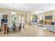 Open concept living and dining area with tile floors, neutral tones, and abundant natural light at 1386 Hazeldene Mnr, Deland, FL 32724