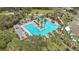 Stunning aerial view of a community pool with a unique center island and luxurious lounge areas at 1386 Hazeldene Mnr, Deland, FL 32724