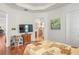 Spacious bedroom features hardwood floors, a tray ceiling, and a connected bathroom at 1684 Victoria Gardens Dr, Deland, FL 32724
