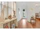 Bright foyer featuring hardwood floors, elegant decor, and a glimpse of the home's open layout at 1684 Victoria Gardens Dr, Deland, FL 32724