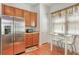 Well-lit kitchen featuring stainless steel appliances and a cozy dining area at 1684 Victoria Gardens Dr, Deland, FL 32724