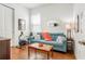 Cozy living room featuring a blue sofa, wooden floors, and natural light at 1684 Victoria Gardens Dr, Deland, FL 32724