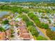 Overhead view of a residential neighborhood with well-maintained homes and lush green trees at 1711 Francisco St, The Villages, FL 32159