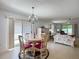 Bright dining area connected to the living space, featuring a round table and sliding glass doors at 1711 Francisco St, The Villages, FL 32159