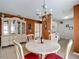 Cozy dining area with a chandelier, a china cabinet, and seating for four, adjacent to the kitchen at 1711 Francisco St, The Villages, FL 32159